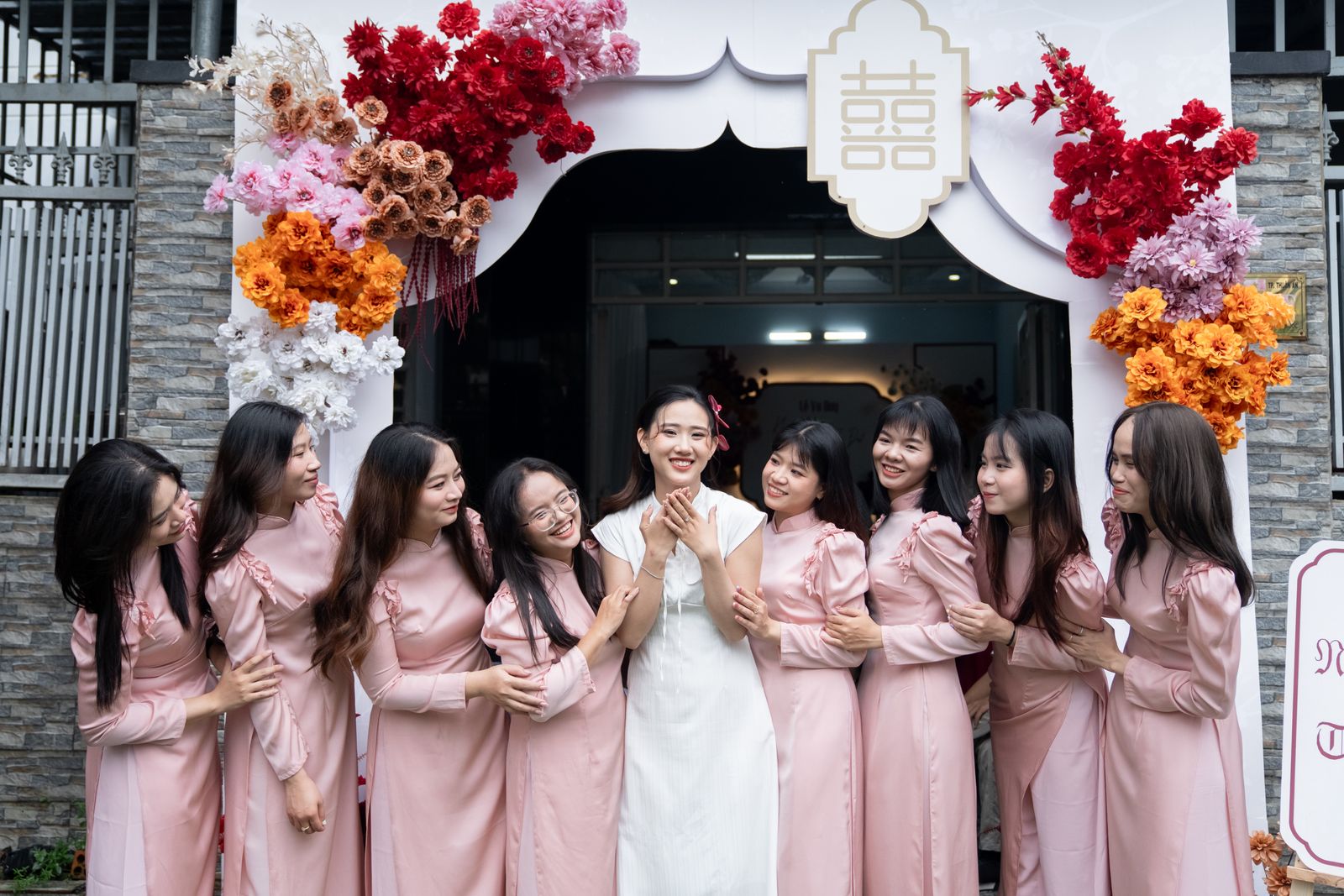 A bride surrounded by friends at an outdoor celebration