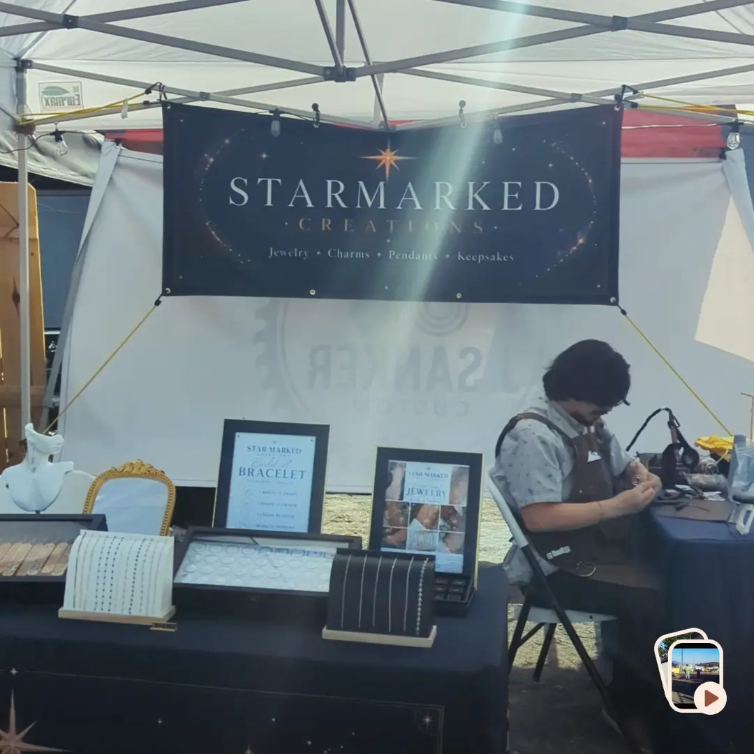The Starmarked Creations jewelry booth set up at a community pop-up