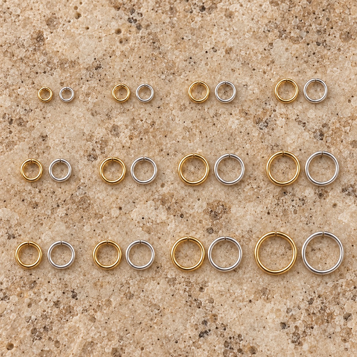 Illustrative progression of sterling silver and 14K gold-filled jump ring diameters on travertine.