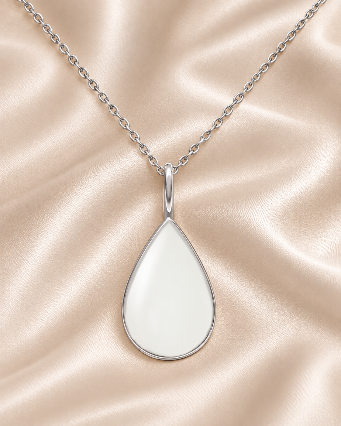 Illustrated silver-colored teardrop Mother’s Milk pendant on ivory champagne satin